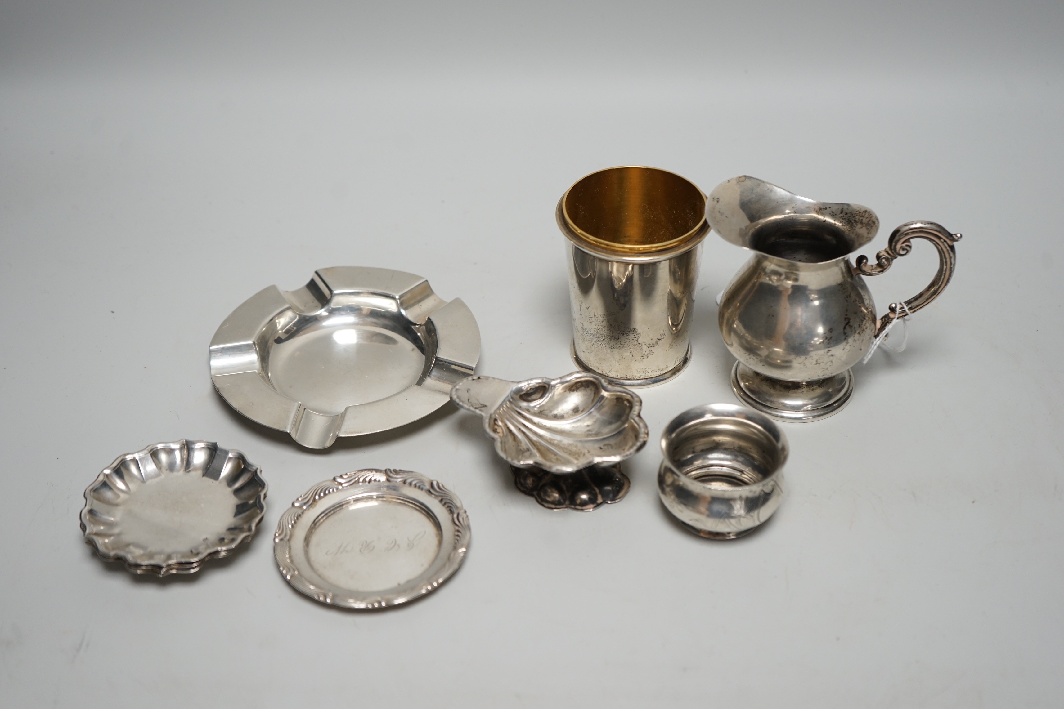 Sundry small silver, including a set of four 800 standard white metal small dishes, a similar shell salt and cream jug, a Tiffany & Co sterling small dish, a modern silver cup base (top missing), a silver ashtray and a R